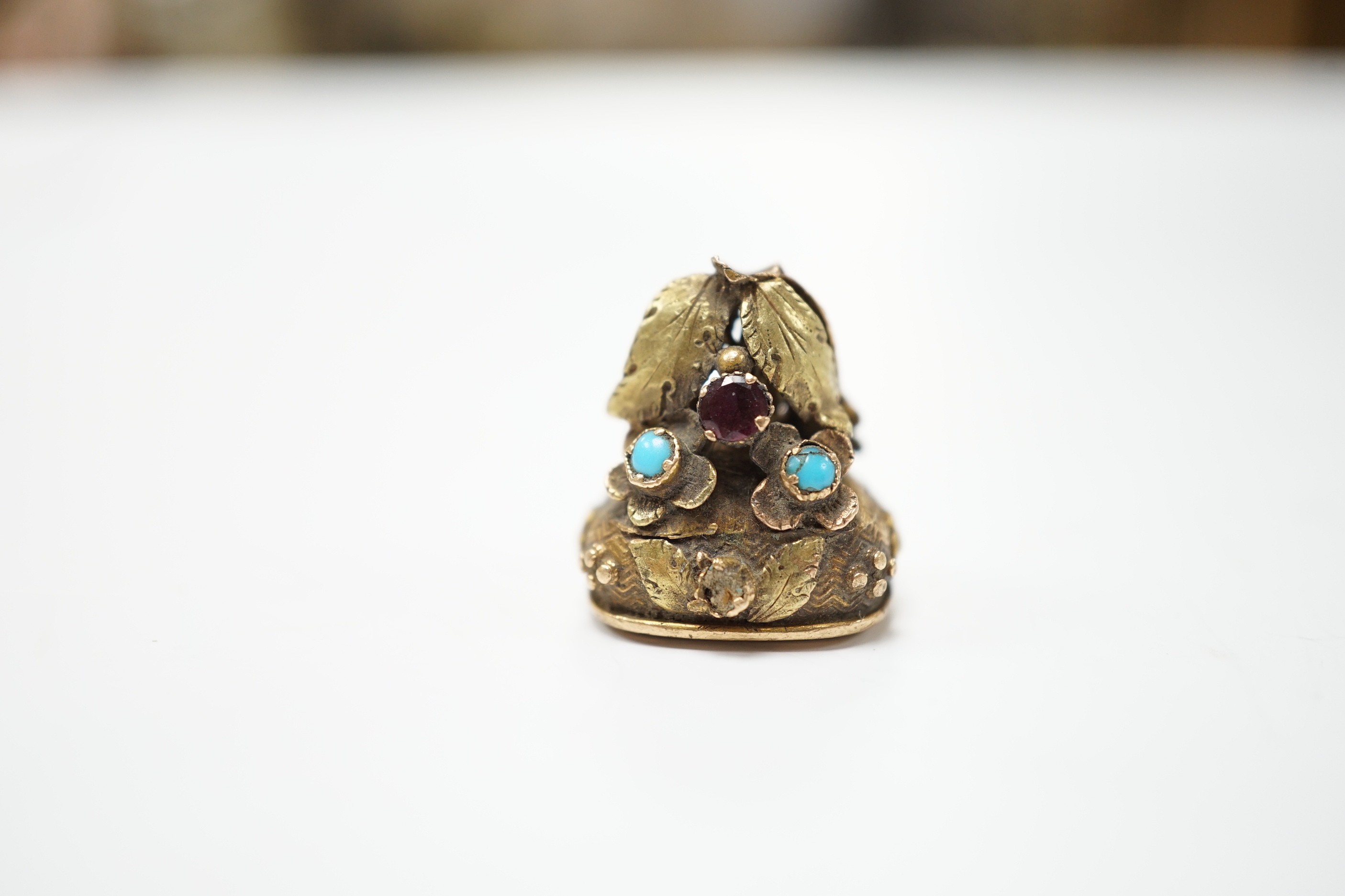 A 19th century yellow metal, garnet and turquoise mounted foil backed amethyst fob seal, the matrix inscribed Lamitie?, 17mm (a.f.).